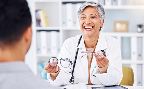 Doctor holding up two glasses choices to person.