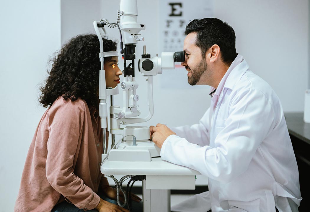 Doctor giving person an eye exam.