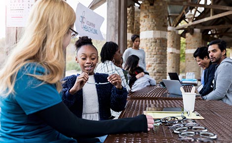Young people trying on glasses in the park.